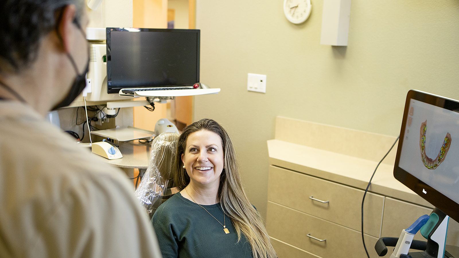 Dr. Scott Bonin reviewing a digital scan on screen with a smiling patient in his Windsor, CA office